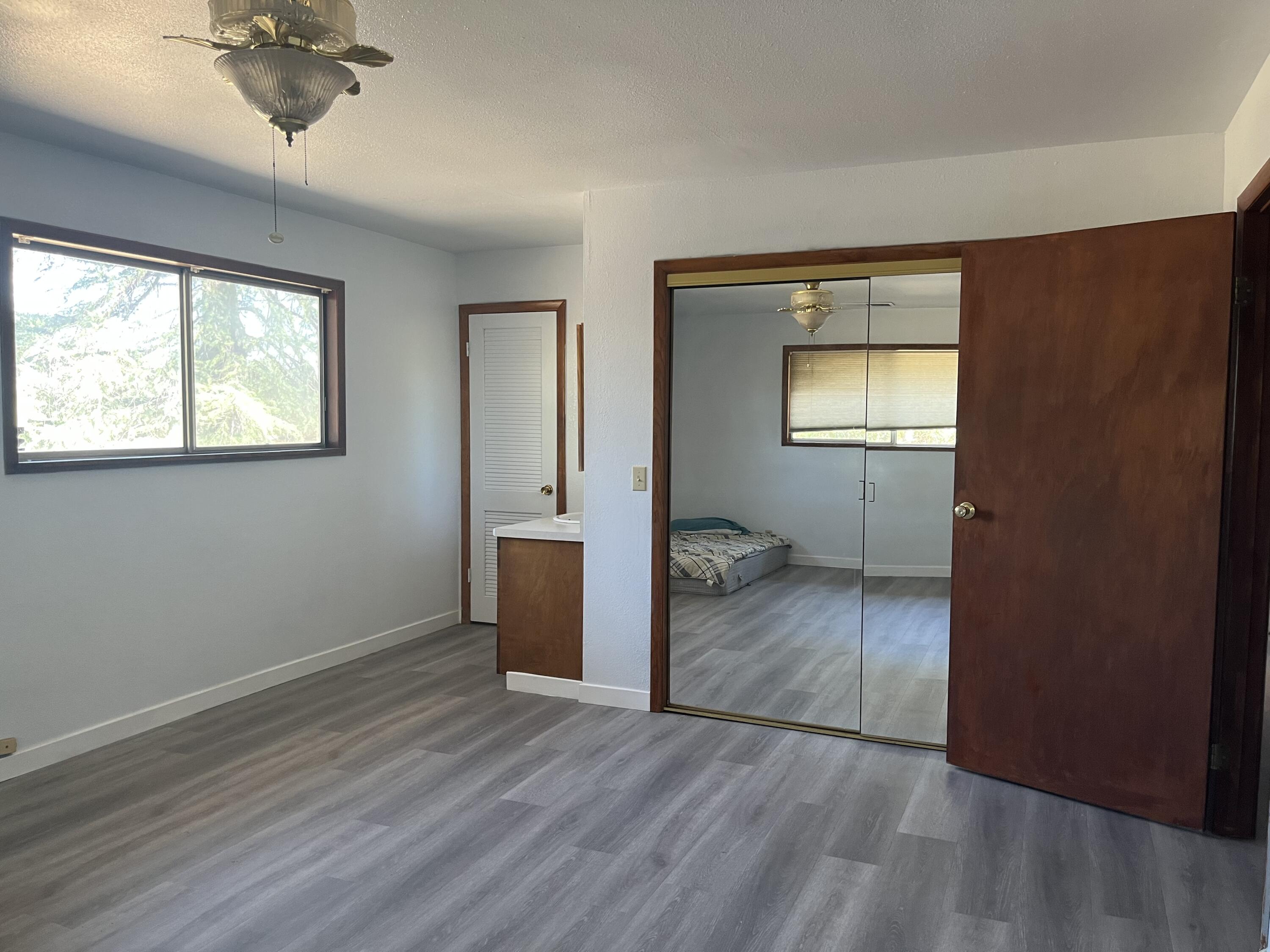 2713 Woodson Avenue Corning, CA 96021 - Photo 12 of 38 wooden floor in an empty room with a window