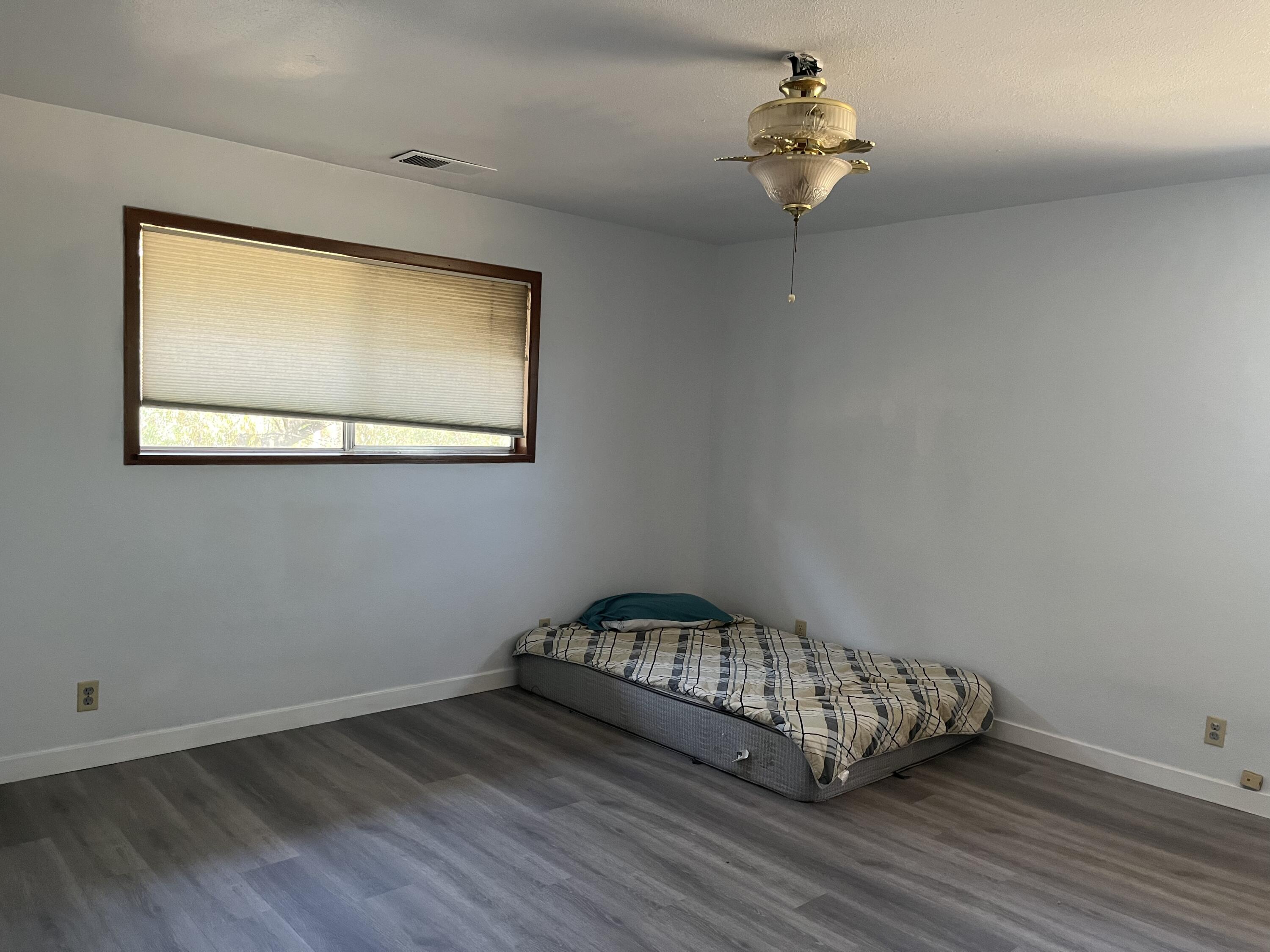 2713 Woodson Avenue Corning, CA 96021 - Photo 14 of 38 a view of a room with wooden floor and ceiling fan