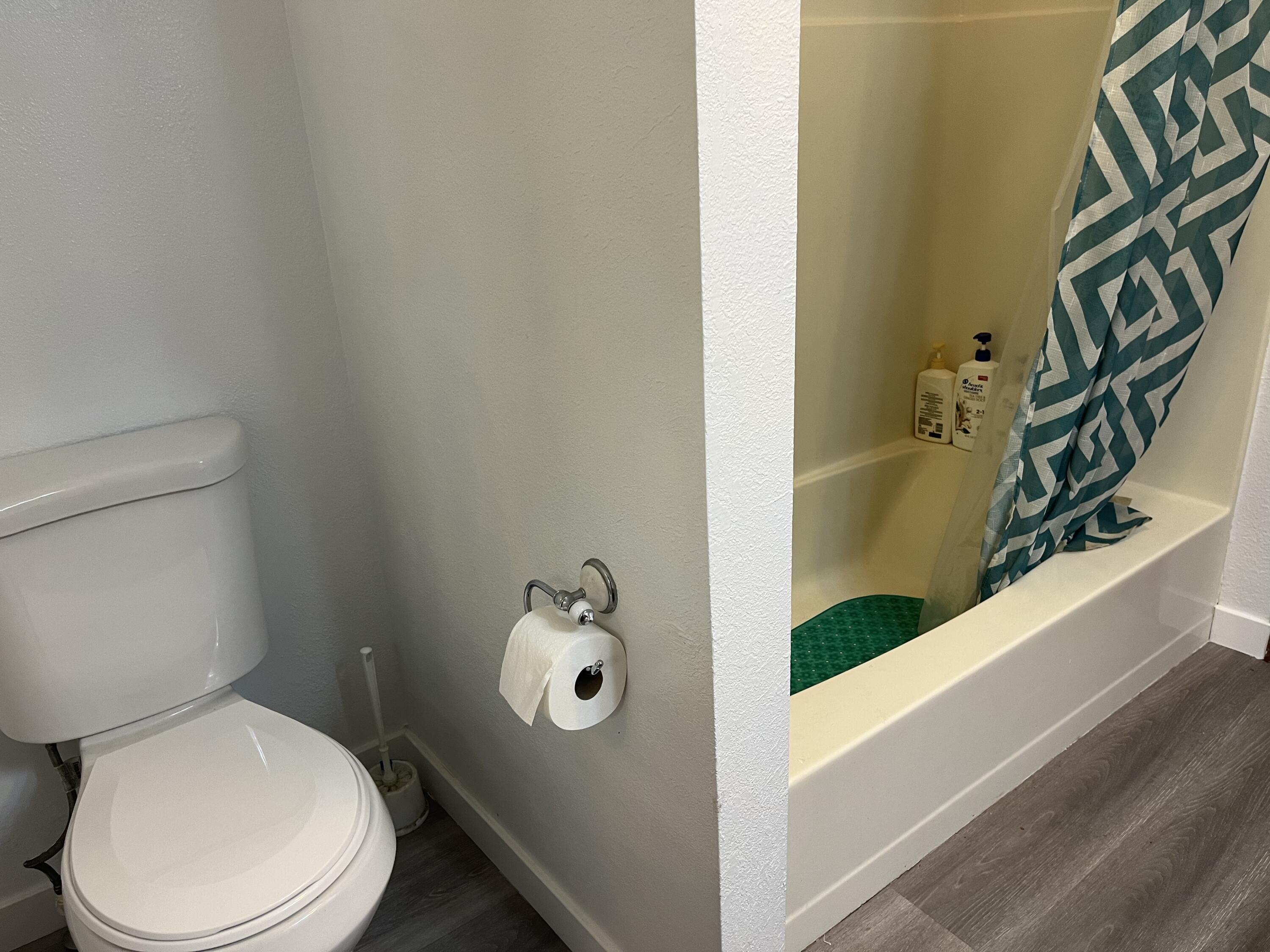 2713 Woodson Avenue Corning, CA 96021 - Photo 19 of 38 a white toilet sitting next to a bathroom sink