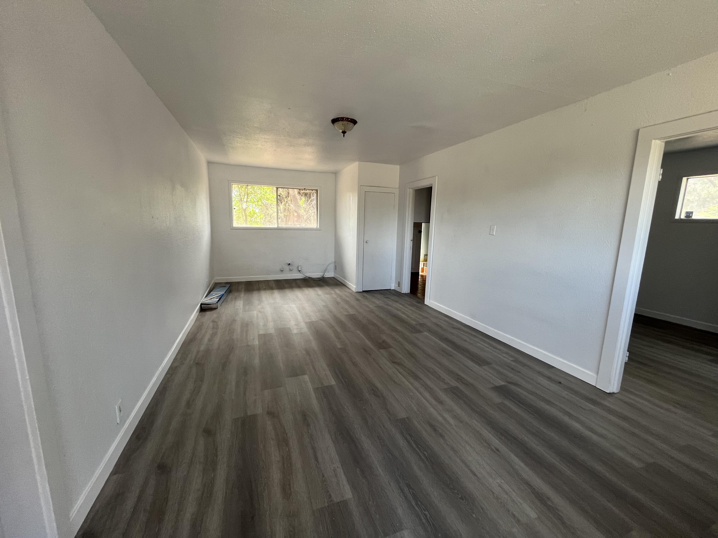 2713 Woodson Avenue Corning, CA 96021 - Photo 24 of 38 a view of an empty room with wooden floor and a window