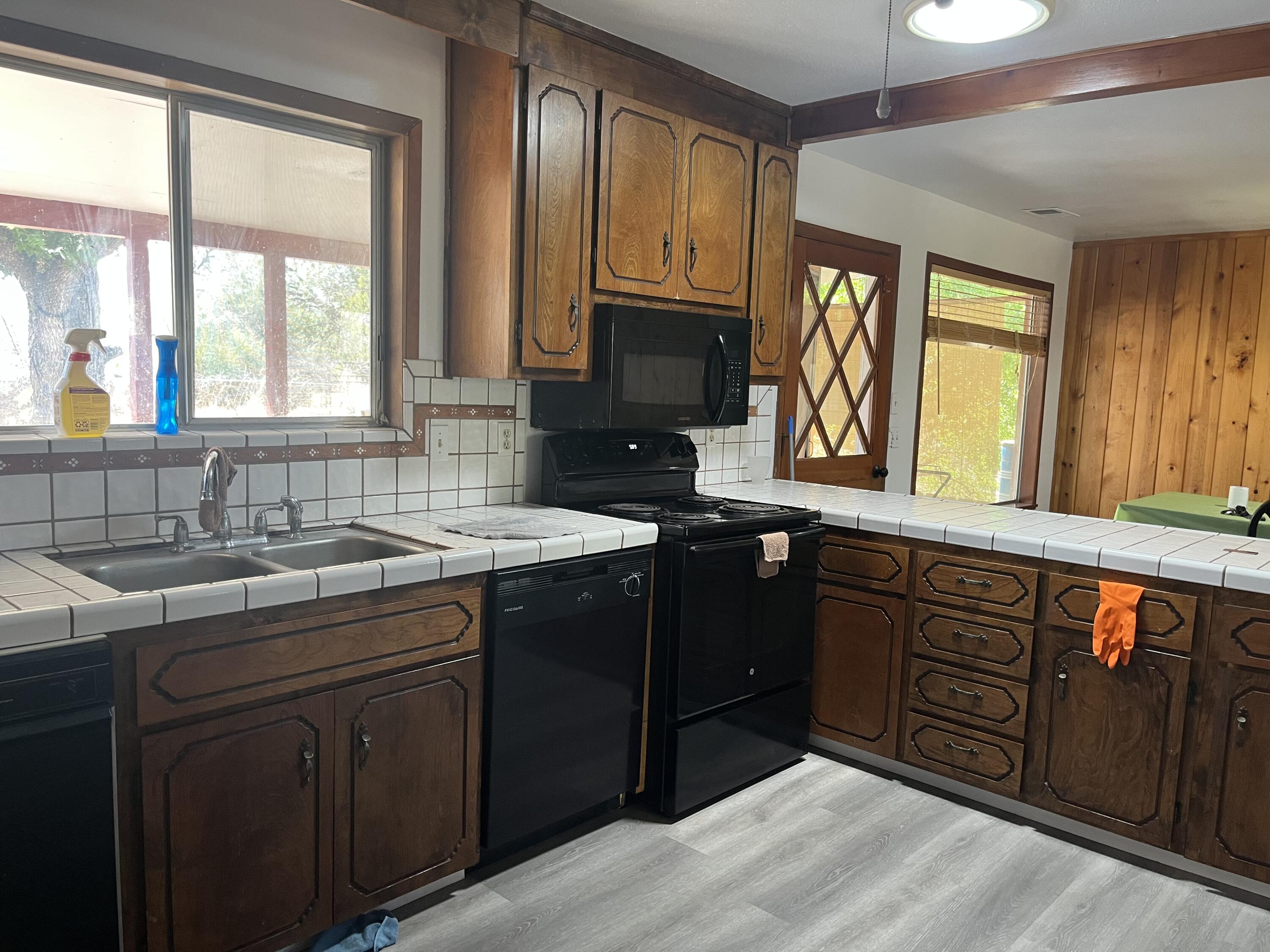 2713 Woodson Avenue Corning, CA 96021 - Photo 6 of 38 a kitchen with stainless steel appliances granite countertop a sink stove and cabinets