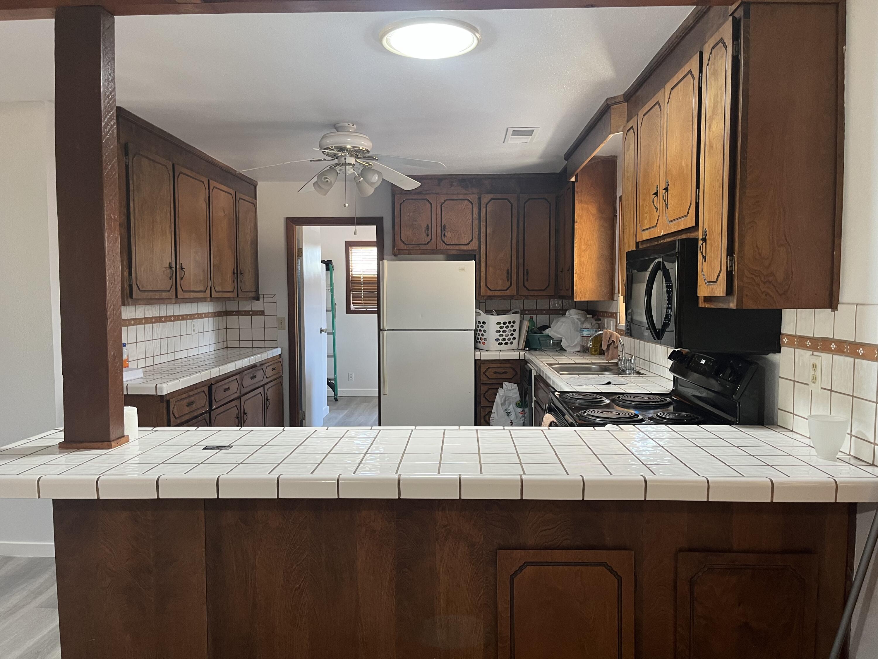 2713 Woodson Avenue Corning, CA 96021 - Photo 7 of 38 a kitchen with a sink refrigerator and cabinets