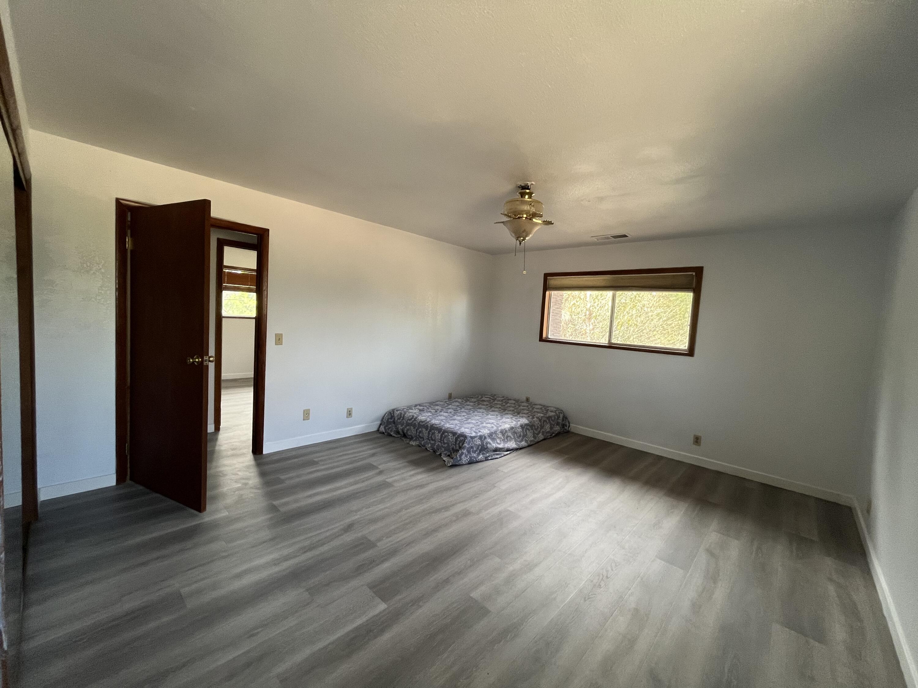2713 Woodson Avenue Corning, CA 96021 - Photo 8 of 38 an empty room with wooden floor cabinet and windows