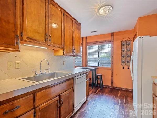 a kitchen with stainless steel appliances granite countertop a sink and cabinets