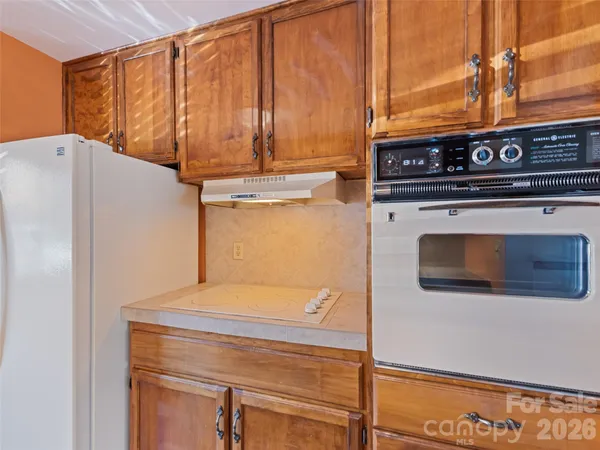a close view of a stove top oven sitting inside of a kitchen