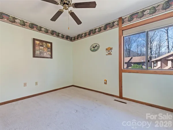 a view of a hallway with a ceiling fan