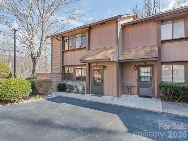 a front view of a brick house with a yard