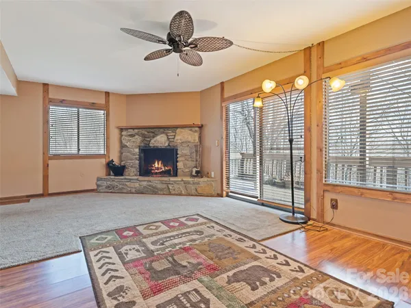 a living room with a fireplace furniture and a large window