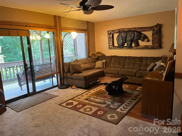 a living room with furniture and a floor to ceiling window
