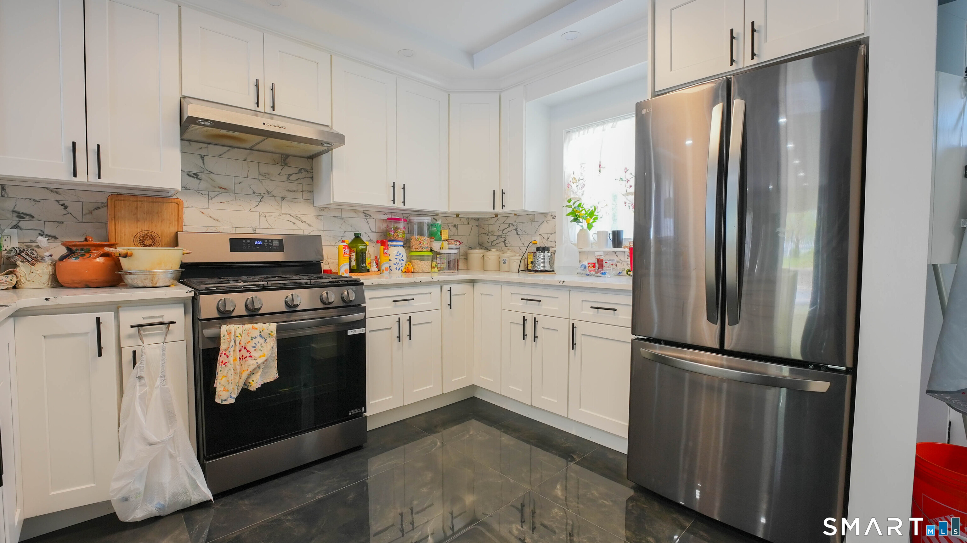849 Frost Road Waterbury, CT 06705 - Photo 19 of 36 a kitchen with a refrigerator sink and cabinets