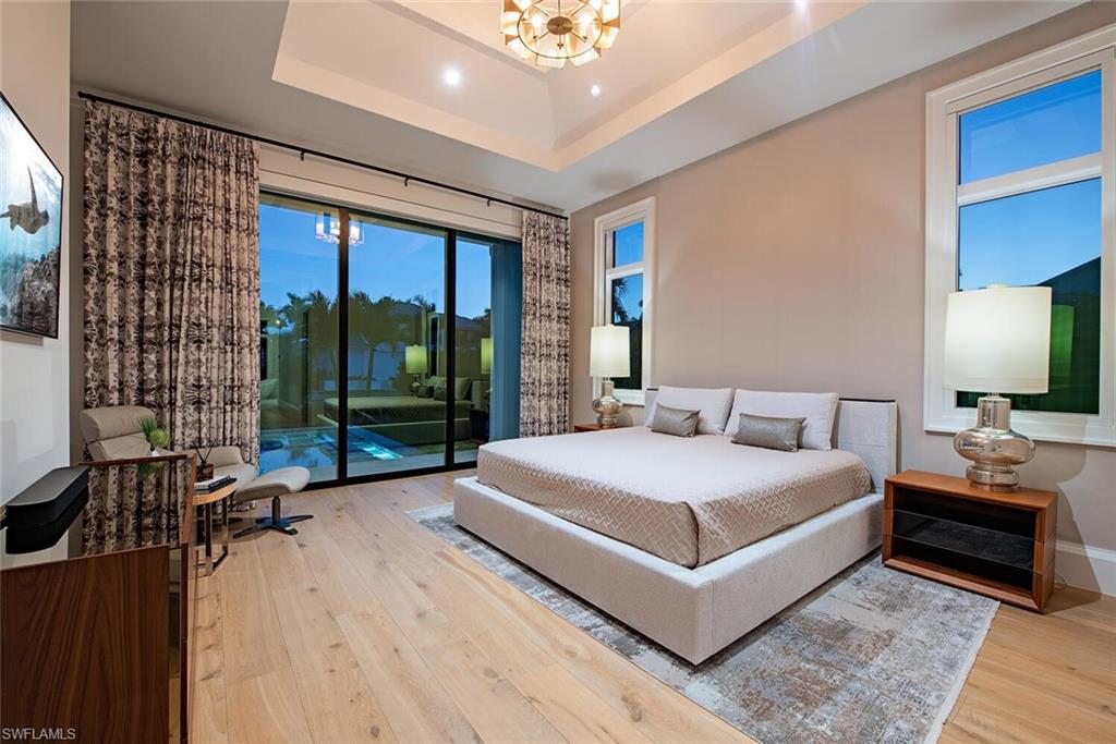 608 16th Avenue South Naples, FL 34102 - Photo 12 of 36 a bedroom with a large bed and a large window