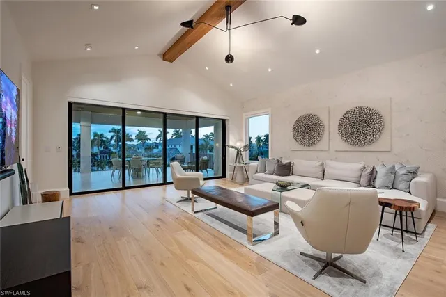 a living room with fireplace furniture and a large window
