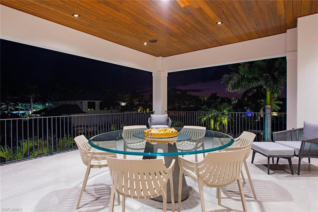 608 16th Avenue South Naples, FL 34102 - Photo 17 of 36 a dining room with furniture and outdoor view