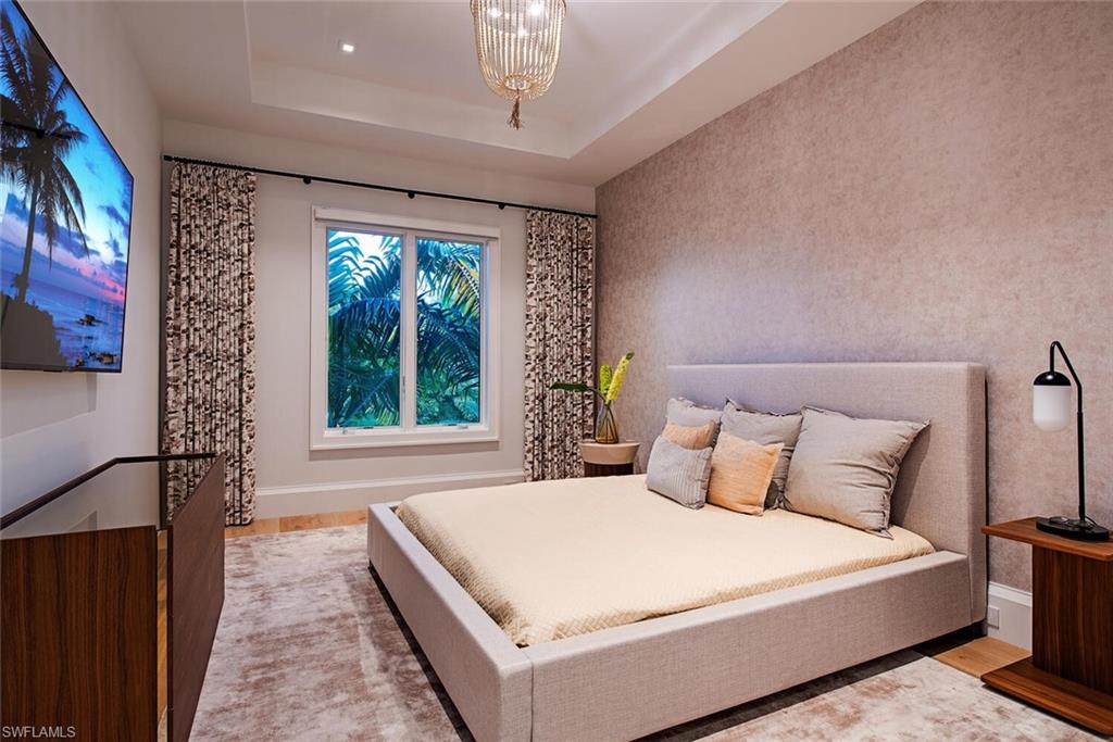 608 16th Avenue South Naples, FL 34102 - Photo 18 of 36 a bedroom with a large bed and a window