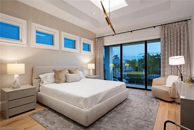 a bedroom with a bed and glass window