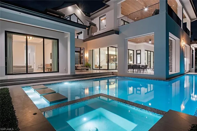 a open kitchen with stainless steel appliances granite countertop a refrigerator and a view of living room