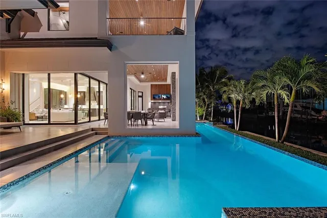 a view of a lobby with a floor to ceiling window and a kitchen
