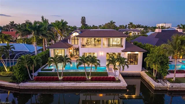 a front view of residential houses with yard and mountain view