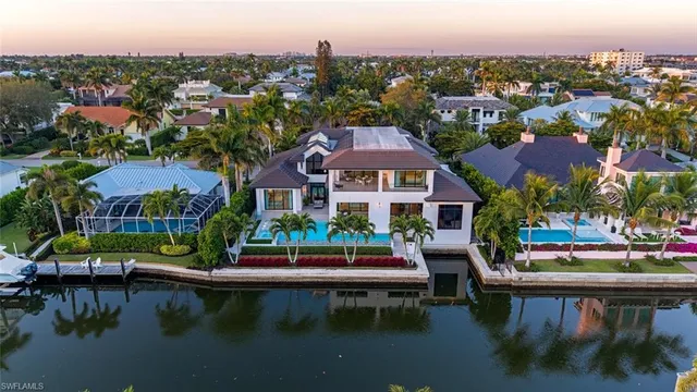 a view of house with yard and lake view