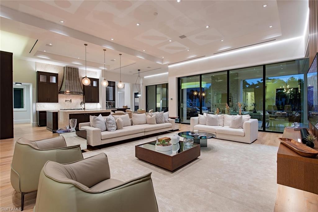 608 16th Avenue South Naples, FL 34102 - Photo 5 of 36 a living room with furniture kitchen view and large windows