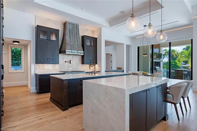 a kitchen with kitchen island granite countertop a sink and a stove