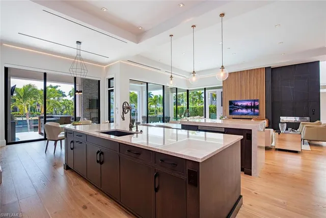 a open kitchen with stainless steel appliances granite countertop a lot of counter space and a wooden floors