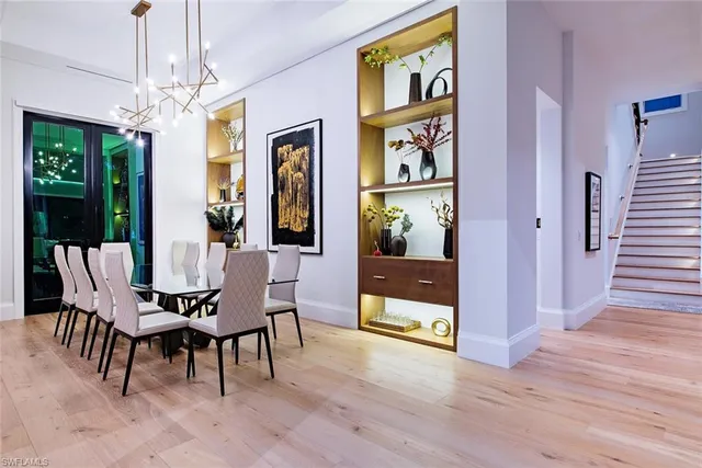 a view of a dining room with furniture wooden floor and chandelier