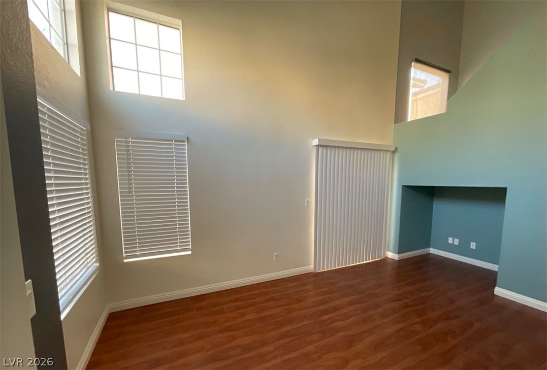 7203 Cestrum Road Las Vegas, NV 89113 - Photo 3 of 22 Soaring vaulted ceilings and polished wood floors frame this versatile living space filled with natural light.