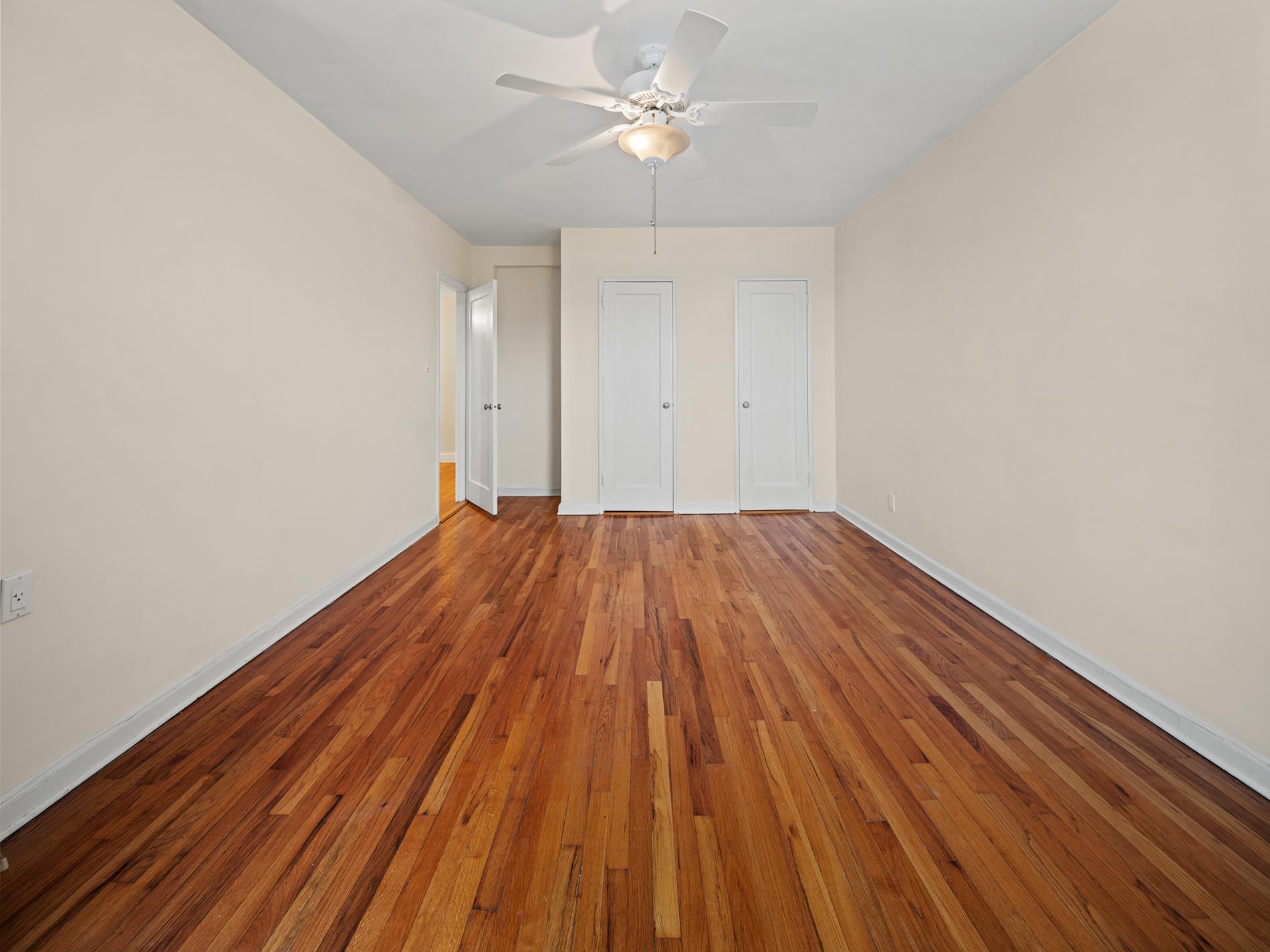 6665 Colonial Road, Unit 5D Brooklyn, NY 11220 - Photo 12 of 18 a view of a room with wooden floor and a ceiling fan