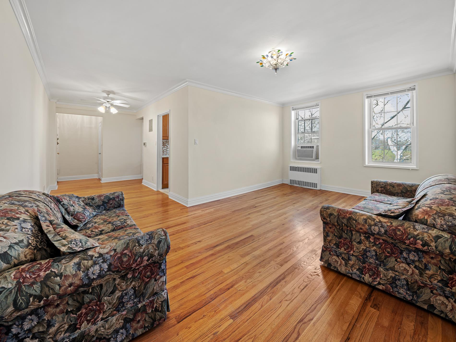 6665 Colonial Road, Unit 5D Brooklyn, NY 11220 - Photo 4 of 18 a living room with furniture and a chandelier