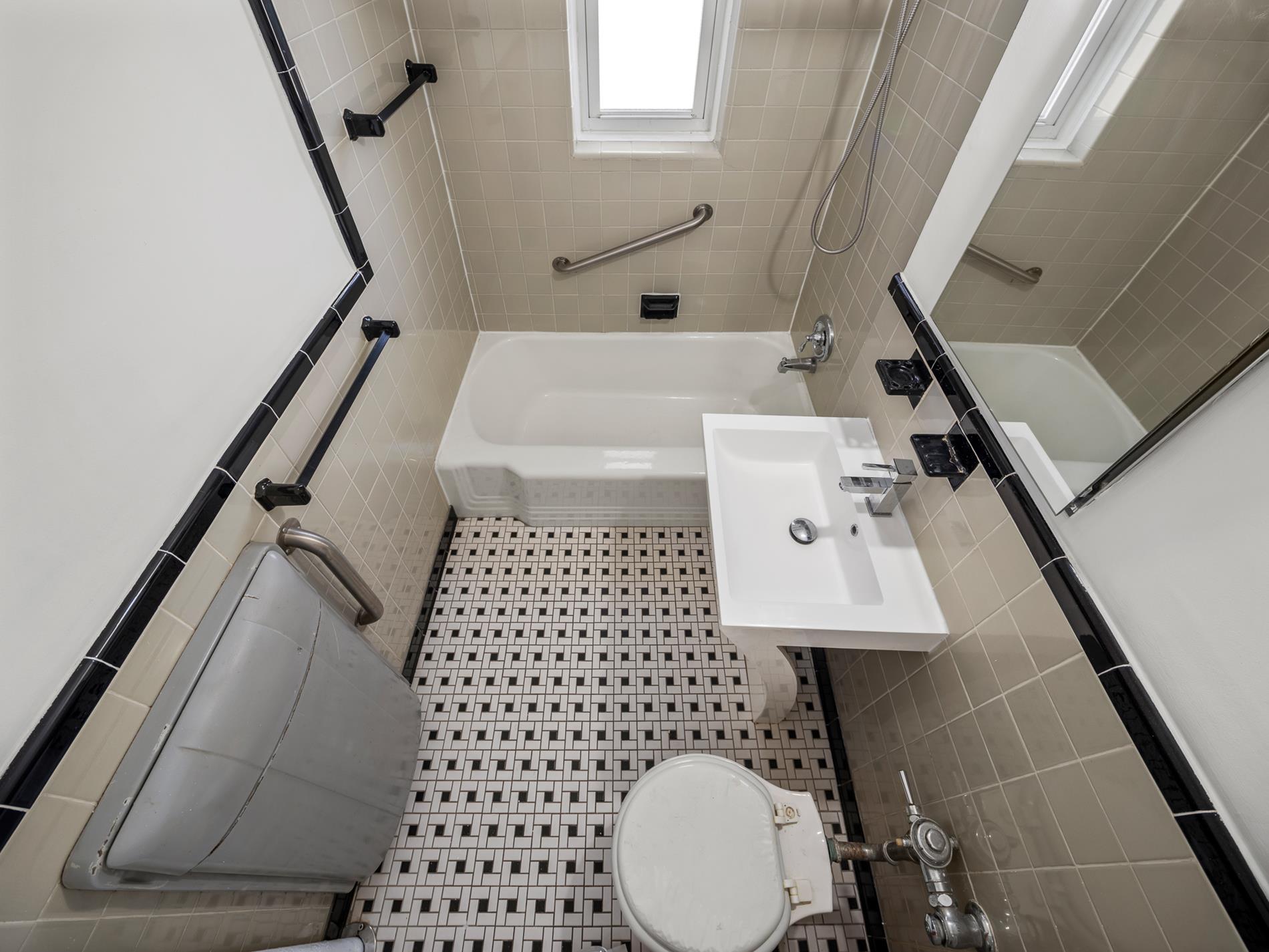 6665 Colonial Road, Unit 5D Brooklyn, NY 11220 - Photo 9 of 18 a bathroom with a sink a toilet and shower