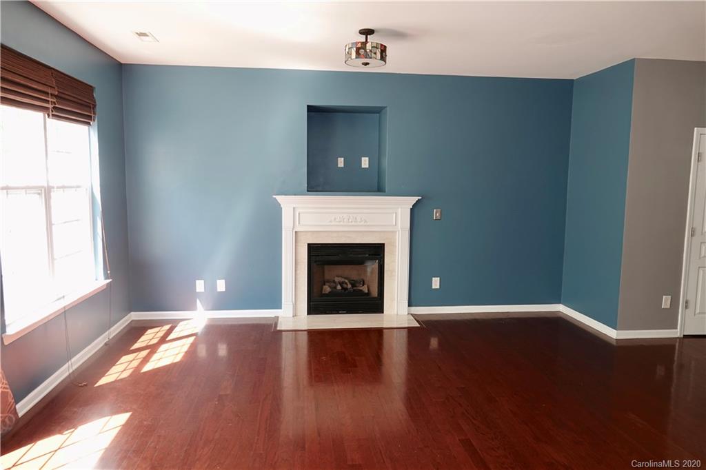974 Copperstone Lane Fort Mill, SC 29708 - Photo 6 of 22 a view of an empty room with wooden floor and a window