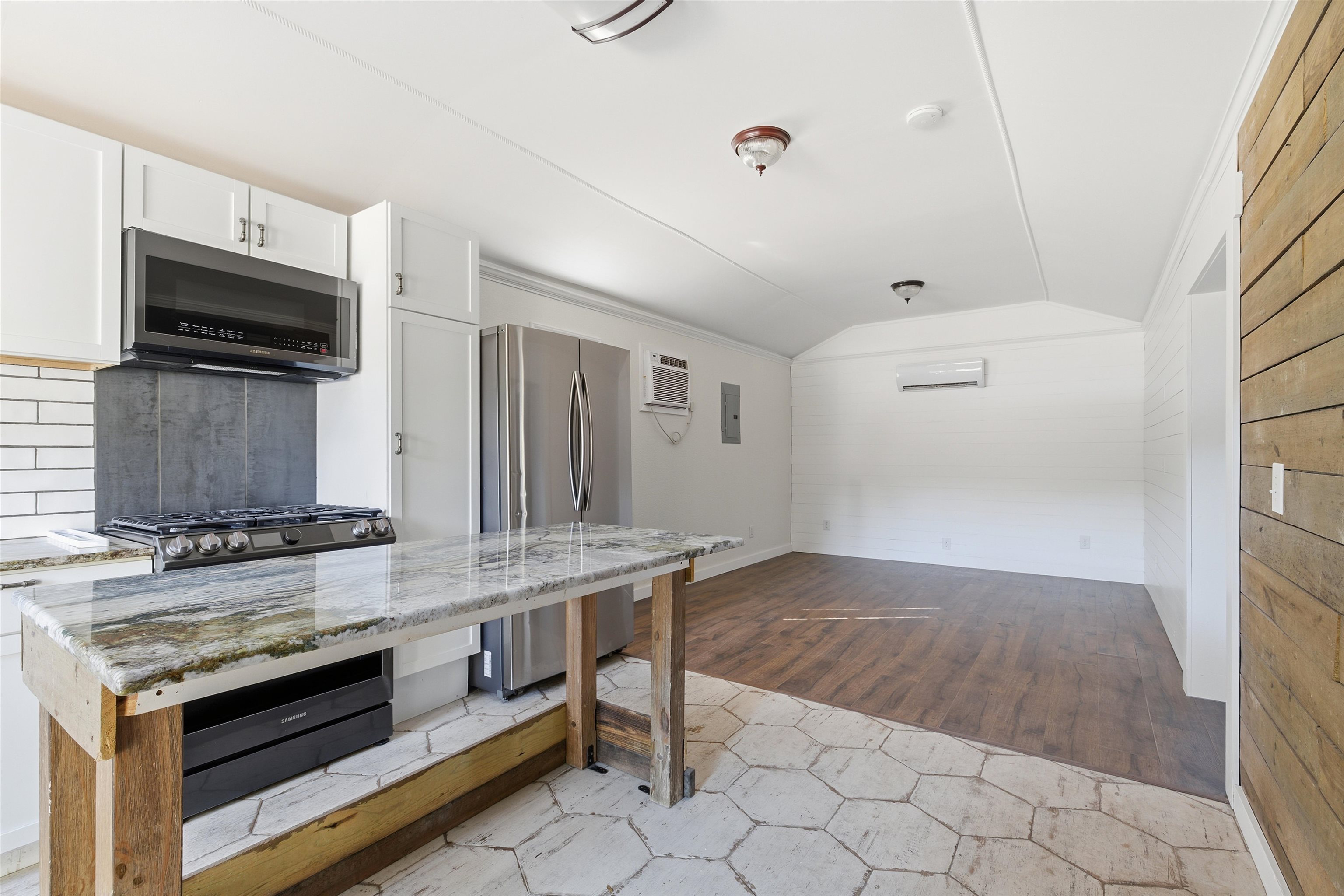 418 Polvado Round Mountain, TX 78663 - Photo 12 of 26 a kitchen with stainless steel appliances granite countertop a stove and a microwave