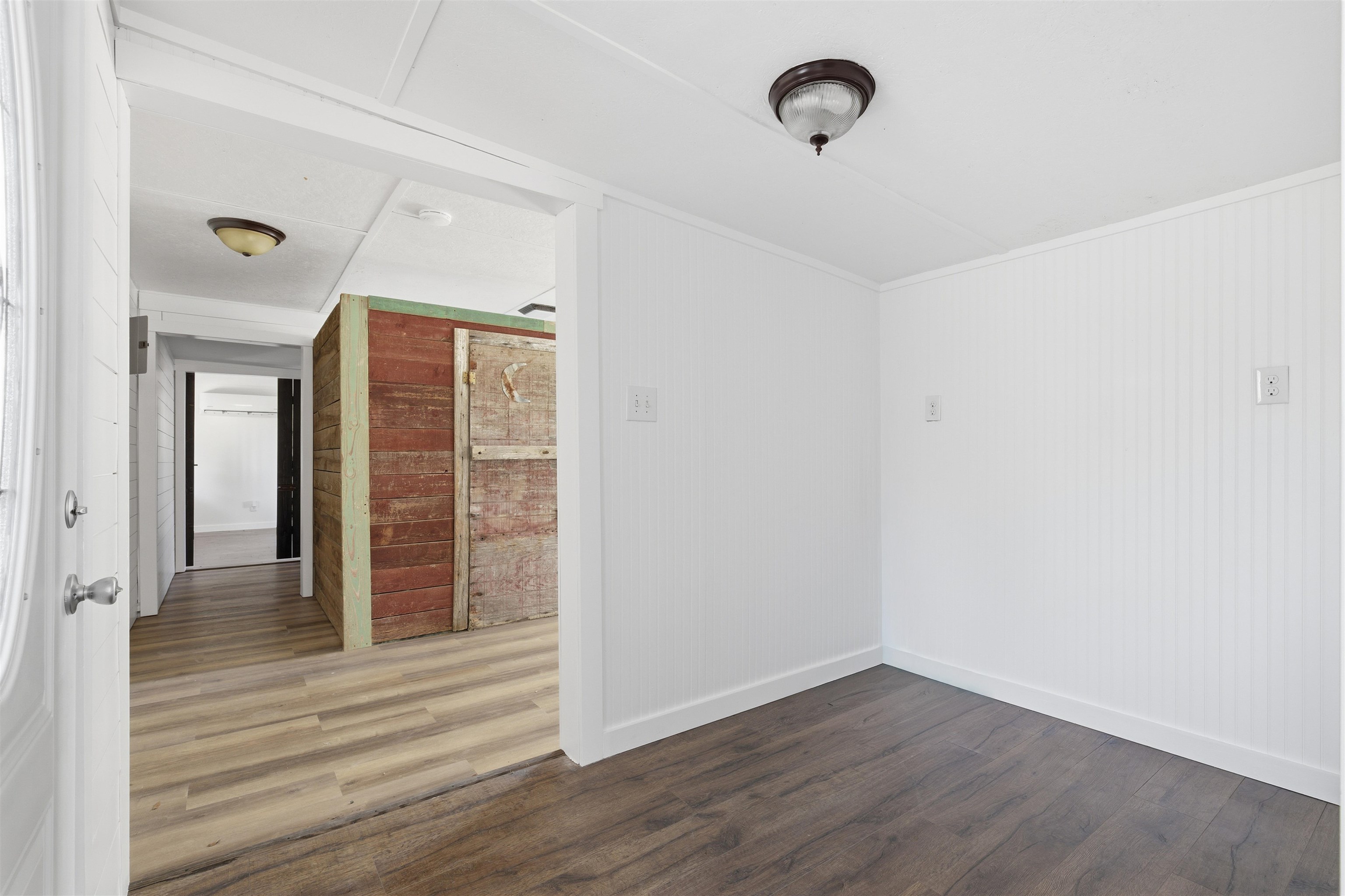 418 Polvado Round Mountain, TX 78663 - Photo 13 of 26 an empty room with wooden floor and windows
