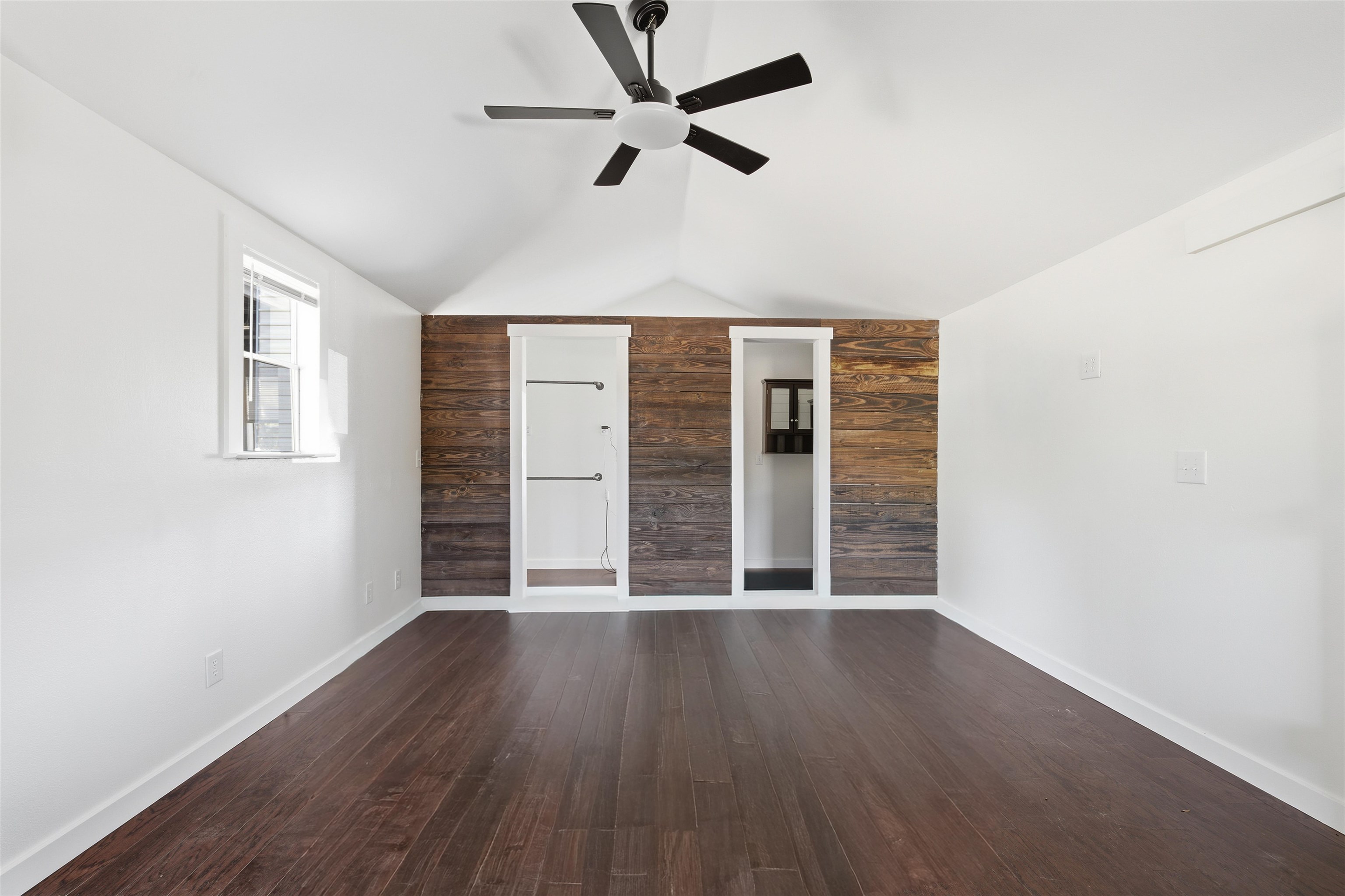 418 Polvado Round Mountain, TX 78663 - Photo 15 of 26 an empty room with wooden floor and windows
