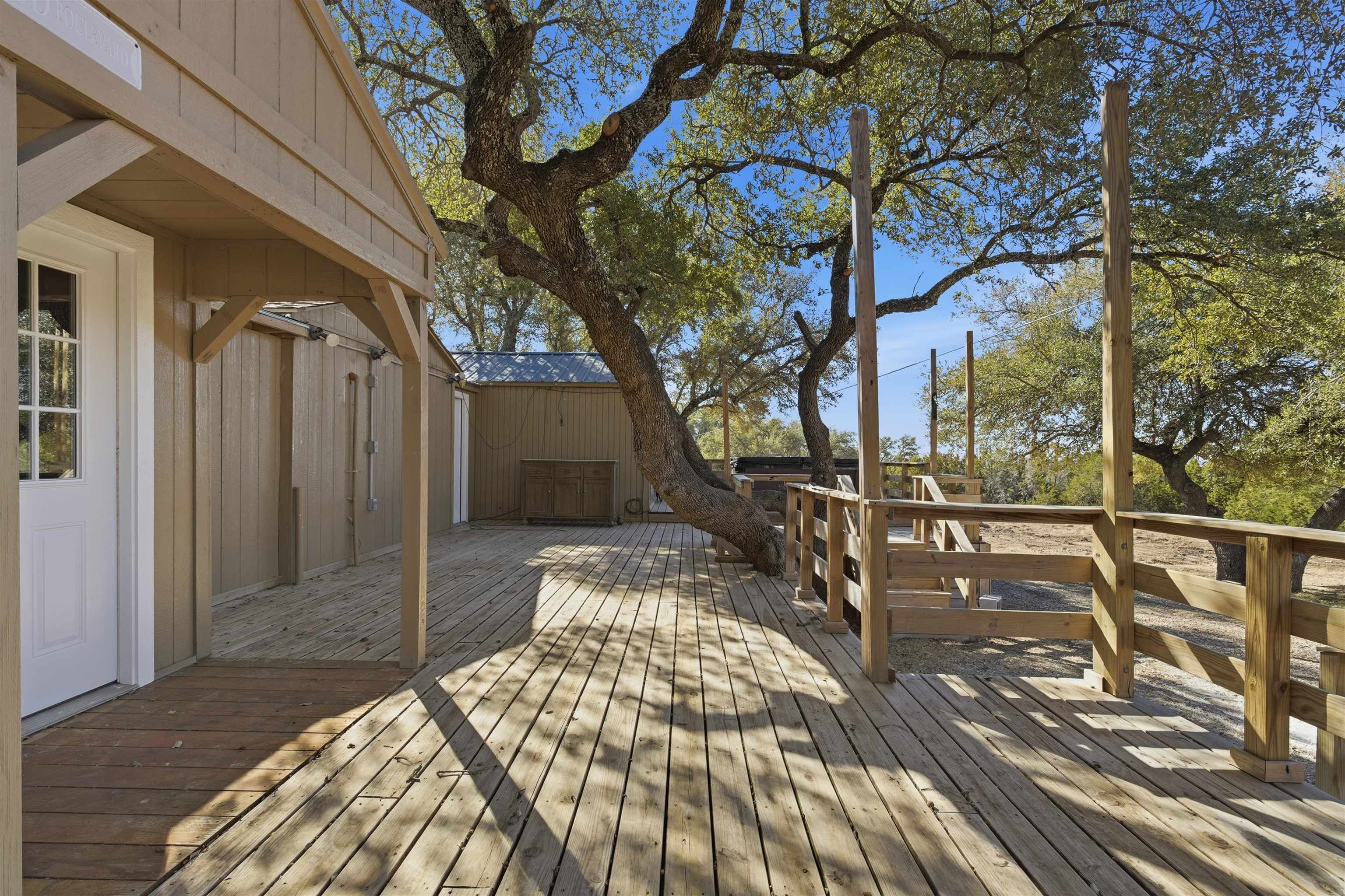 418 Polvado Round Mountain, TX 78663 - Photo 4 of 26 a view of balcony with wooden floor and bench