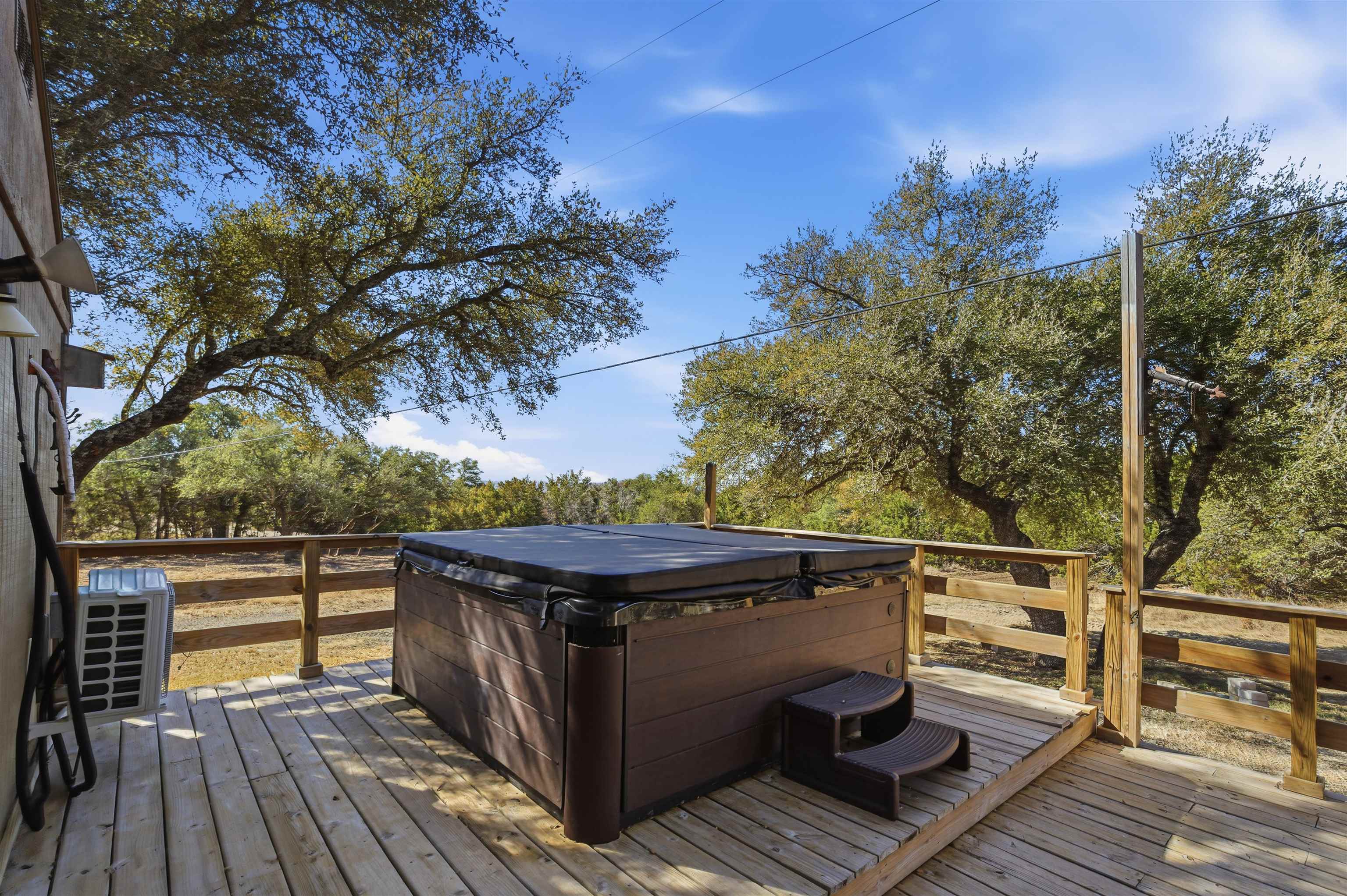 418 Polvado Round Mountain, TX 78663 - Photo 5 of 26 a view of outdoor space with wooden floor and city view