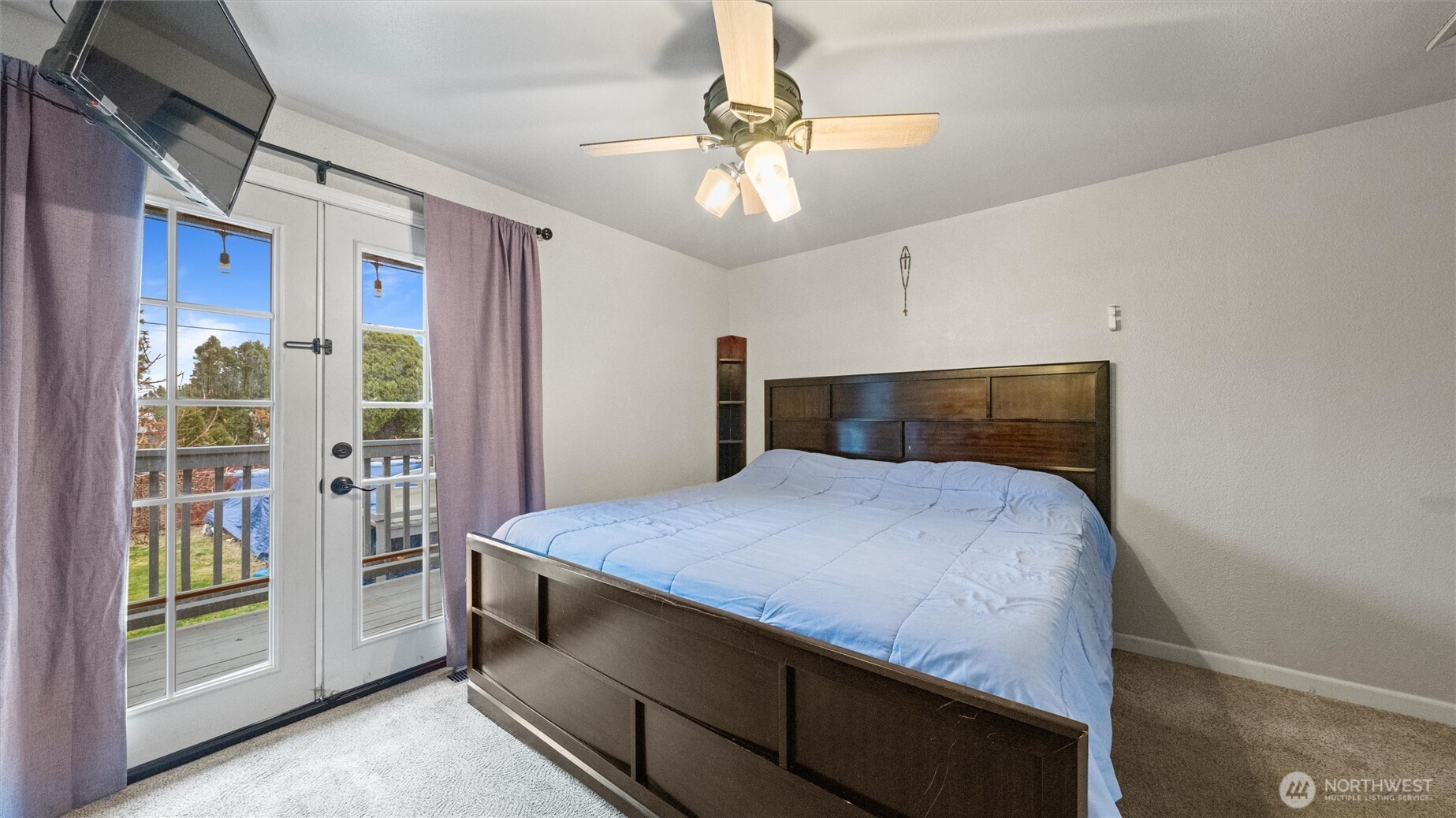 321 South Sheppard Street Kennewick, WA 99336 - Photo 12 of 22 a bedroom with a bed and a chandelier
