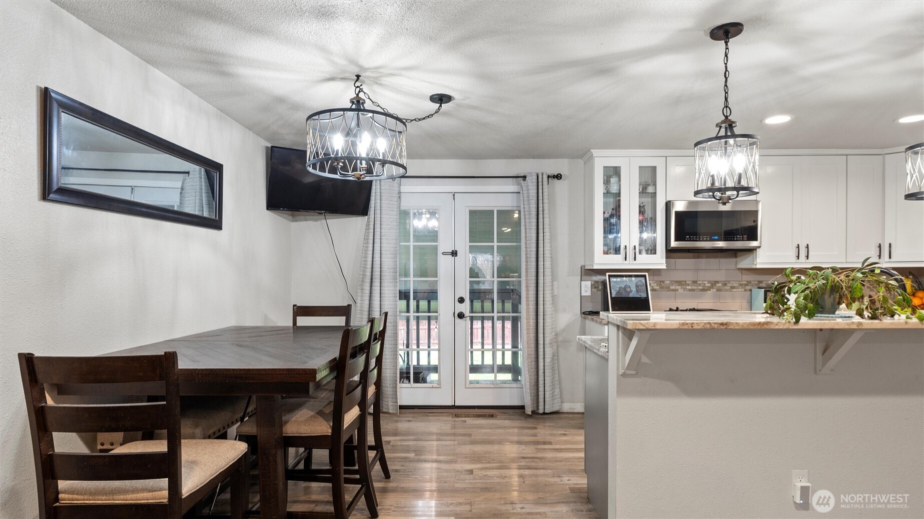 321 South Sheppard Street Kennewick, WA 99336 - Photo 6 of 22 a view of a dining room with furniture a chandelier and wooden floor