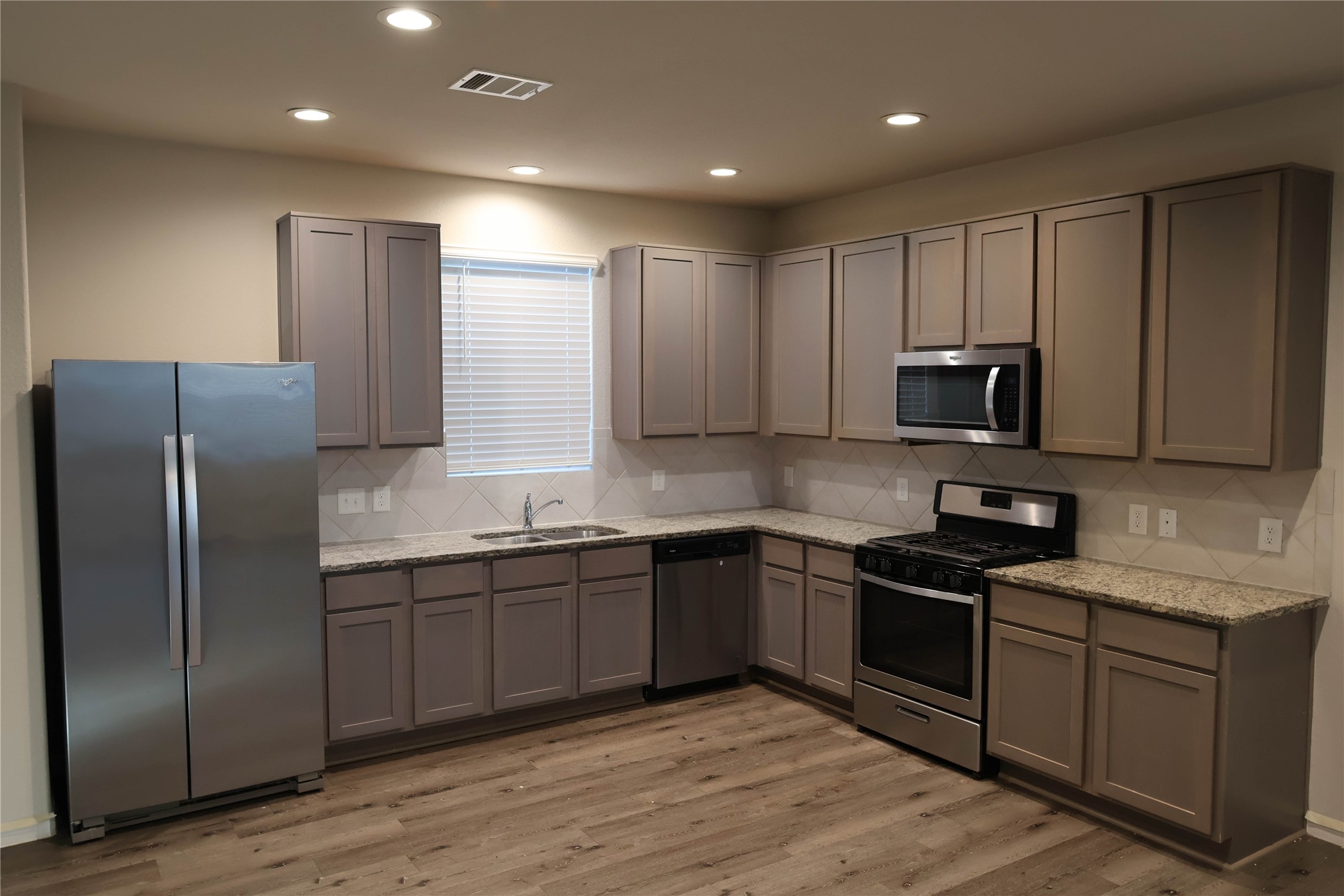 2522 Sturgeon Way Conroe, TX 77384 - Photo 5 of 19 a kitchen with stainless steel appliances granite countertop a sink stove and refrigerator