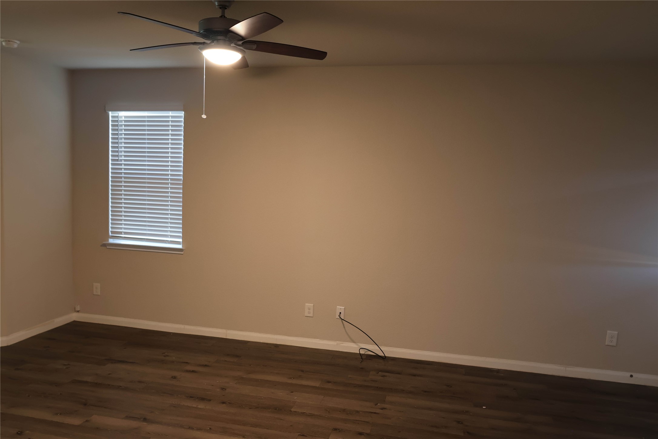 2522 Sturgeon Way Conroe, TX 77384 - Photo 6 of 19 a view of an empty room with wooden floor and a window