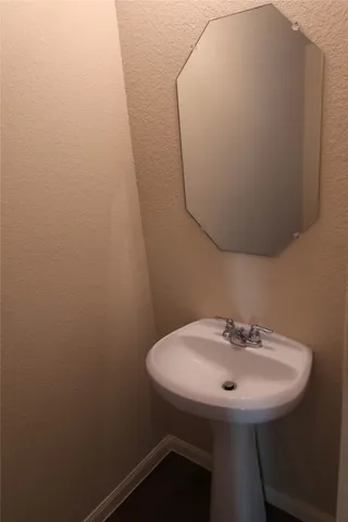 a view of a room with wooden floor and a window