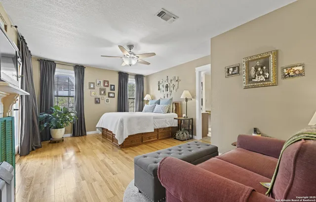 a bedroom with a bed chandelier and a window