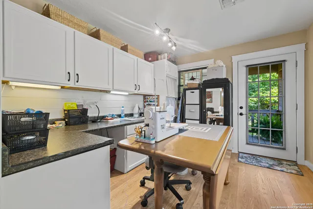 a kitchen with a table chairs stove and cabinets