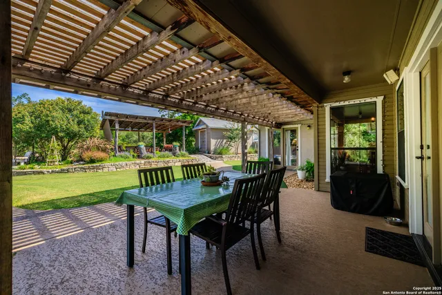 a view of a porch with furniture and a yard