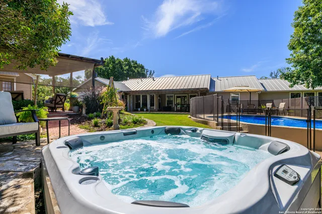 a view of a swimming pool with sitting area