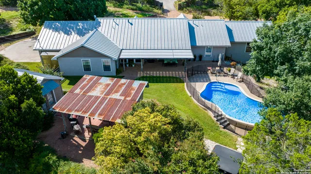 a aerial view of a house with swimming pool garden and patio