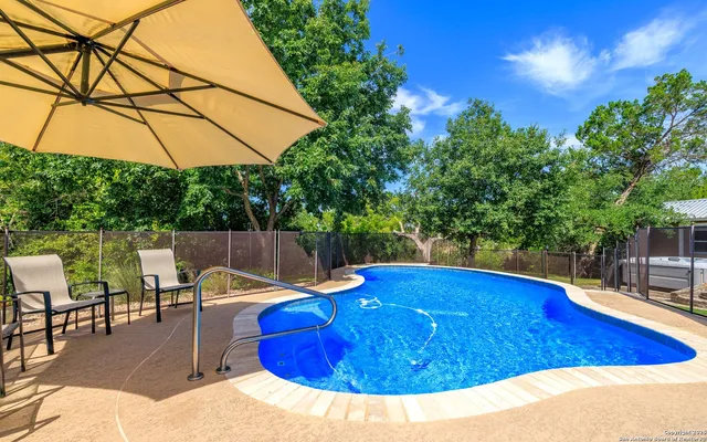 a view of a swimming pool with a patio