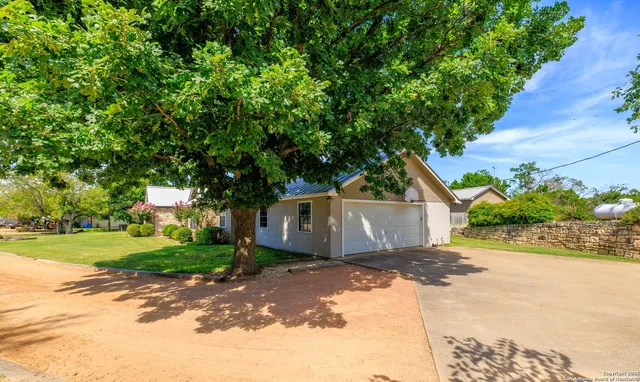 a view of a house with a yard and garage