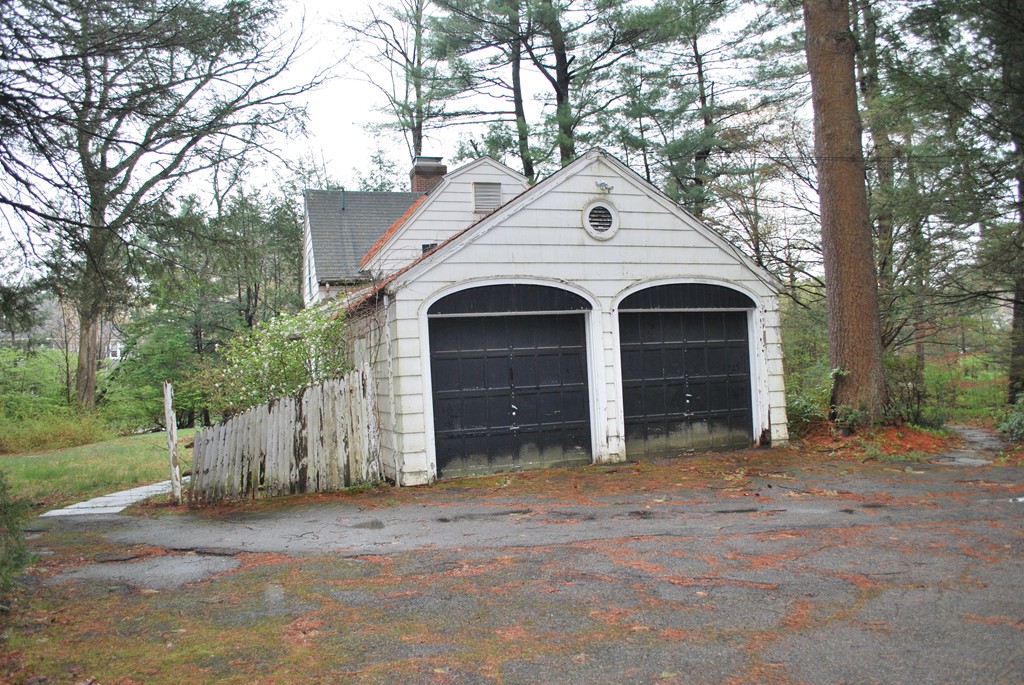 276 Grove Street Wellesley, MA 02482 - Photo 18 of 20 a front view of a house with a yard and garage